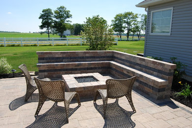Patio - mid-sized contemporary backyard brick patio idea in Other with a fire pit and a pergola