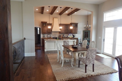 Mid-sized farmhouse dark wood floor and brown floor great room photo in Other with beige walls and no fireplace