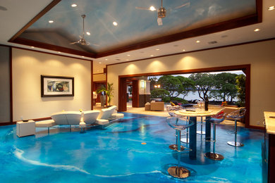 Example of a huge minimalist open concept concrete floor living room design in Hawaii with a bar, beige walls and a concealed tv