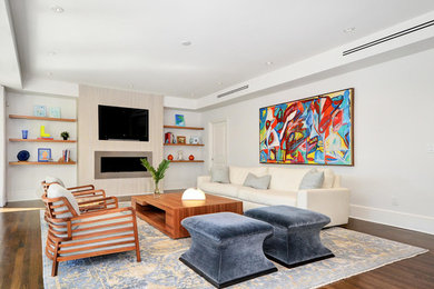Inspiration for a mid-sized contemporary formal and loft-style dark wood floor and brown floor living room remodel in Tampa with beige walls, a concrete fireplace, a wall-mounted tv and a wood stove