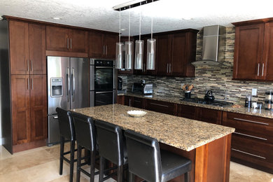 Large tuscan u-shaped travertine floor and beige floor eat-in kitchen photo in Miami with an undermount sink, shaker cabinets, dark wood cabinets, granite countertops, multicolored backsplash, mosaic tile backsplash, stainless steel appliances, an island and multicolored countertops
