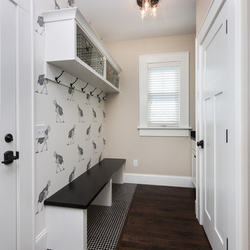 Cubby storage above built in bench with inlaid tile floor