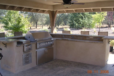 Design ideas for an expansive backyard patio in Sacramento with an outdoor kitchen.