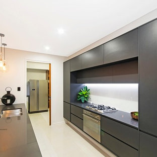 Large modern kitchen pantry appliance - Large minimalist galley ceramic floor kitchen pantry photo in Townsville with an undermount sink, gray cabinets, white backsplash, glass sheet backsplash, stainless steel appliances and an island