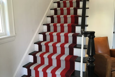 Photo of a medium sized bohemian carpeted curved staircase in New York with carpeted risers.