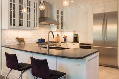 Design ideas for a mid-sized transitional u-shaped separate kitchen in DC Metro with an undermount sink, shaker cabinets, white cabinets, granite benchtops, white splashback, ceramic splashback, stainless steel appliances, ceramic floors, a peninsula, grey floor and black benchtop.