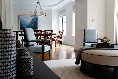 Inspiration for a mid-sized transitional formal and loft-style medium tone wood floor living room remodel in New York with white walls and a wall-mounted tv
