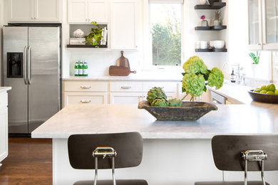 Example of a large transitional u-shaped dark wood floor enclosed kitchen design in Tampa with a farmhouse sink, shaker cabinets, white cabinets, marble countertops, white backsplash, subway tile backsplash, stainless steel appliances and a peninsula