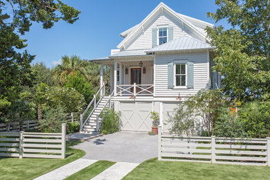 Inspiration for a mid-sized beach style three-storey white house exterior in Charleston with wood siding, a gable roof and a metal roof.