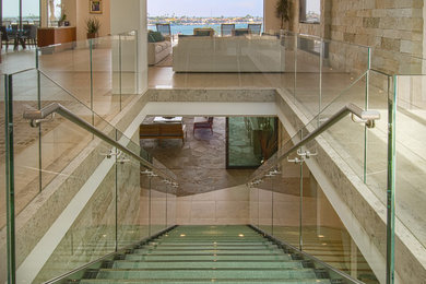 Inspiration for a large contemporary glass straight open and glass railing staircase remodel in Orange County