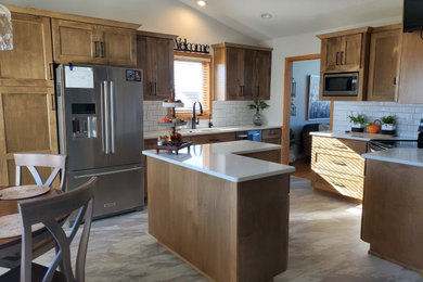 Inspiration for a large modern l-shaped vinyl floor, white floor and vaulted ceiling eat-in kitchen remodel in Other with an undermount sink, shaker cabinets, medium tone wood cabinets, quartzite countertops, white backsplash, ceramic backsplash, stainless steel appliances, an island and white countertops