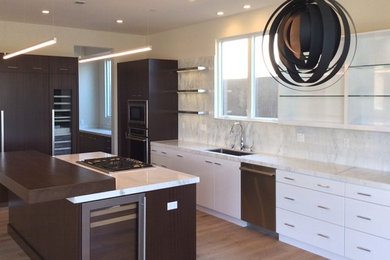 Example of a large trendy medium tone wood floor eat-in kitchen design in Los Angeles with a single-bowl sink, flat-panel cabinets, dark wood cabinets, marble countertops, white backsplash, stone slab backsplash, paneled appliances and an island