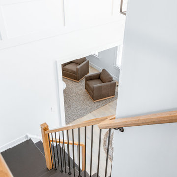 Modern Transitional Stairwell - High-Contrast Millwork and Oak Accents