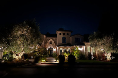 Large mediterranean beige two-story stucco house exterior idea in Sacramento with a tile roof and a brown roof