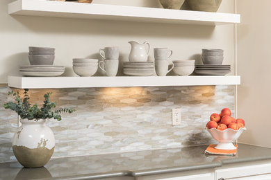 Example of a mid-sized transitional medium tone wood floor and brown floor open concept kitchen design in Other with white cabinets, quartz countertops and an island