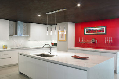 Example of a mid-sized minimalist l-shaped porcelain tile and beige floor eat-in kitchen design in Miami with an undermount sink, flat-panel cabinets, white cabinets, marble countertops, gray backsplash, marble backsplash, stainless steel appliances, an island and gray countertops