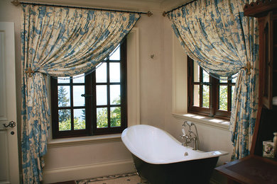 Claw-foot bathtub - mid-sized traditional master dark wood floor and brown floor claw-foot bathtub idea in Seattle with gray walls