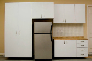 Example of a mid-sized classic attached two-car garage workshop design in Other