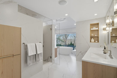Large minimalist master multicolored tile and porcelain tile marble floor, multicolored floor and double-sink bathroom photo in New York with flat-panel cabinets, light wood cabinets, a wall-mount toilet, multicolored walls, an integrated sink, quartz countertops, a hinged shower door, white countertops, a niche and a floating vanity