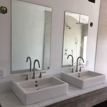 Twin Vessel Sinks on Concrete Look Vanity With Floating Mirrors