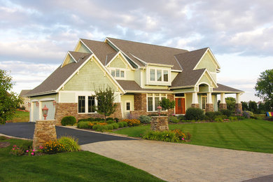 Example of a large classic green two-story mixed siding exterior home design in Minneapolis with a shingle roof