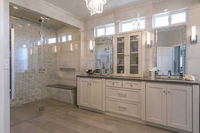 This is an example of a large transitional master bathroom in San Francisco with shaker cabinets, white cabinets, a curbless shower, gray tile, porcelain tile, grey walls, porcelain floors, a drop-in sink, engineered quartz benchtops, beige floor and a hinged shower door.
