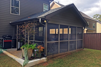 Inspiration for a mid-sized timeless back porch remodel in Atlanta with a roof extension
