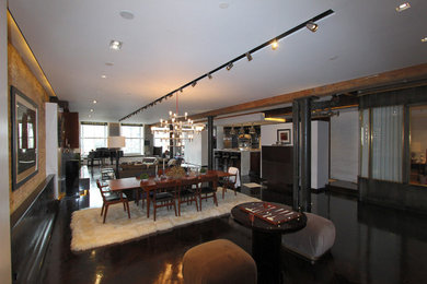 Living room - large modern open concept black floor living room idea in New York with white walls