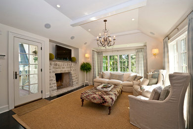 Living room - mid-sized traditional dark wood floor living room idea in Other with white walls, a standard fireplace, a stone fireplace and a media wall
