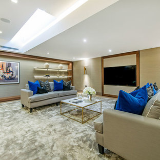 Photo of a large traditional basement in London with beige walls.