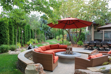 Mid-sized contemporary backyard patio in Boise with a fire feature, no cover and concrete pavers.