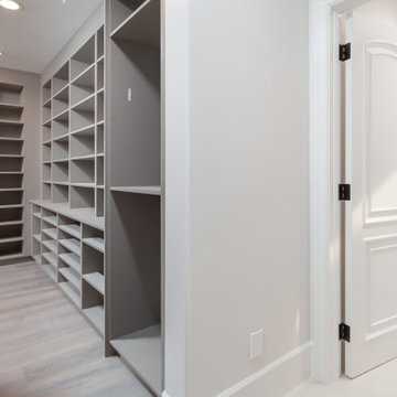 Primary Walk-In Closet with Custom Built-In Shelving – Newport Coast