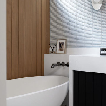 Natural Beauty Meets Modern Design: Wood Panel Wall and White Tub
