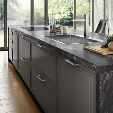 Contemporary grey kitchen with marble top and matching entertainment center