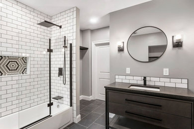 Bathroom/laundry room - large modern master white tile and subway tile porcelain tile, gray floor and single-sink bathroom/laundry room idea in Philadelphia with quartz countertops, a hinged shower door and black countertops