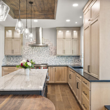 Close-up of White Marble Waterfall Island with Stainless Steel Gas Range and Geo