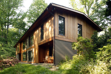 Mid-sized modern beige two-story wood exterior home idea in DC Metro with a clipped gable roof