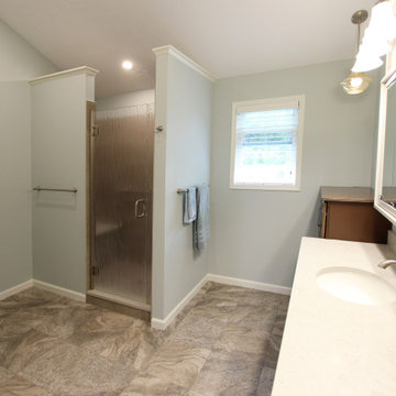 Warm Gray Vanity with Maple Truffle Accent Linen Cabinet and Tiled Shower