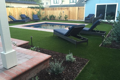 Example of a large transitional backyard brick and rectangular lap pool house design in Orange County