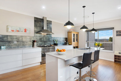 Inspiration for a modern eat-in kitchen in Sydney with an undermount sink, white cabinets, grey splashback, ceramic splashback, stainless steel appliances, bamboo floors and with island.