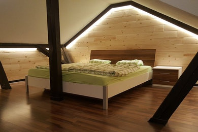 Inspiration for a mid-sized country master bedroom in Berlin with laminate floors and brown floor.