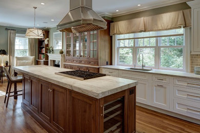 Inspiration for a large transitional single-wall eat-in kitchen in New York with an undermount sink, shaker cabinets, white cabinets, beige splashback, subway tile splashback, stainless steel appliances, medium hardwood floors, with island, quartzite benchtops, brown floor and grey benchtop.