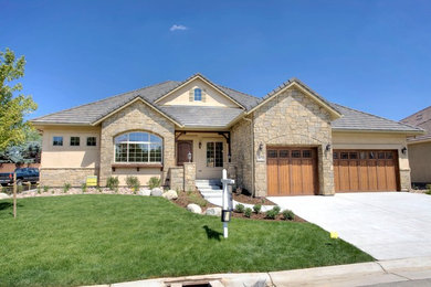 Mid-sized traditional beige one-story stone exterior home idea in Denver