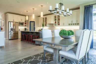 Inspiration for a transitional l-shaped ceramic tile and gray floor kitchen remodel in Other with an undermount sink, recessed-panel cabinets, white cabinets, quartz countertops, white backsplash, mosaic tile backsplash, stainless steel appliances, an island and white countertops