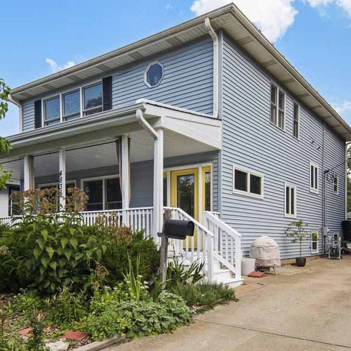 Mid-sized traditional blue two-story concrete fiberboard and clapboard house exterior idea in Chicago with a hip roof, a shingle roof and a gray roof