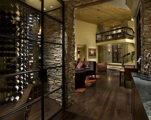 Modern Wine Cellar Dunedin Inspiration for a small contemporary wine cellar remodel in Other with dark hardwood floors and display