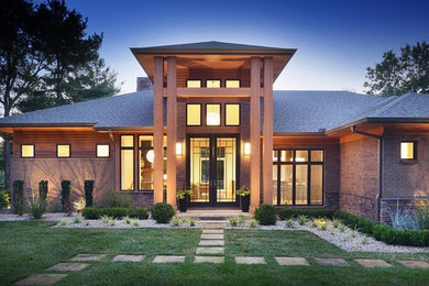 Photo of a contemporary two-storey brick red exterior in Nashville with a hip roof.