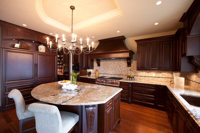 Open concept kitchen - huge rustic u-shaped porcelain tile and beige floor open concept kitchen idea in Other with an undermount sink, raised-panel cabinets, dark wood cabinets, granite countertops, red backsplash, porcelain backsplash, stainless steel appliances and a peninsula