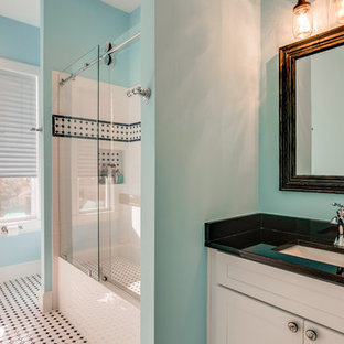 Example of a classic 3/4 black tile, black and white tile, white tile and ceramic tile mosaic tile floor and white floor bathroom design in Houston with shaker cabinets, white cabinets, blue walls, an undermount sink, quartz countertops and black countertops