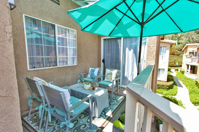 Patio - small coastal backyard patio idea in Orange County with decking and a roof extension